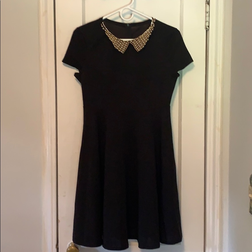 Black dress with decorative collar.